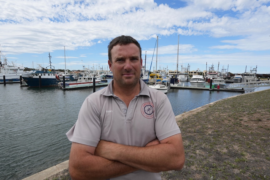 A commercial fisher on the water's edge.
