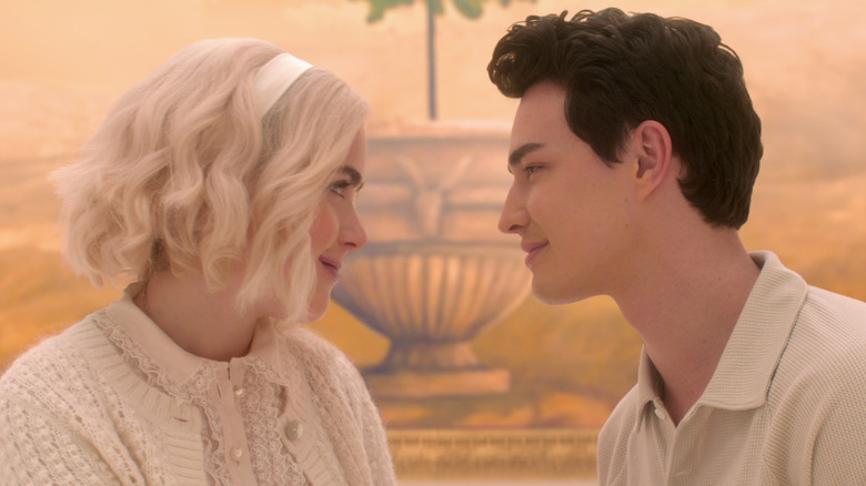 Kiernan Shipka's Sabrina Spellman and Gavin Leatherwood's Nicholas Scratch smiling at each other on Chilling Adventures of Sabrina