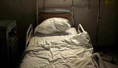 a hospital room with a bed and a monitor