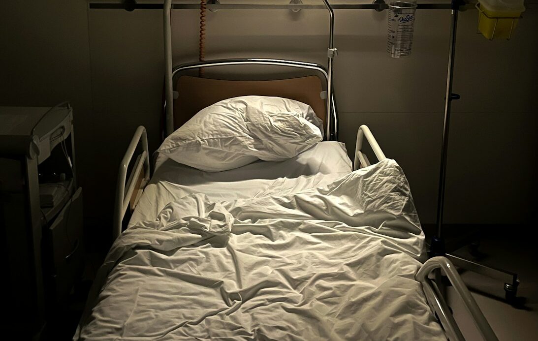 a hospital room with a bed and a monitor