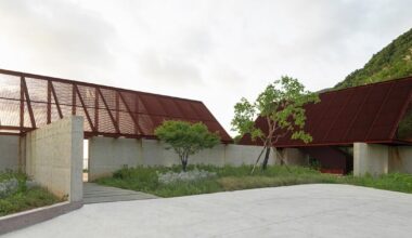 corten-clad twin pavilions frame sea views along chinese coast