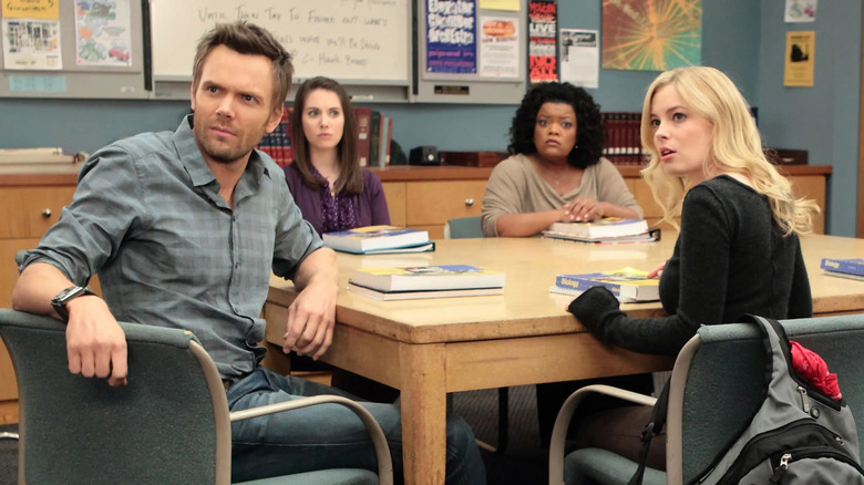 Jeff, Annie, Shirley, and Britta sitting around a study table in Community