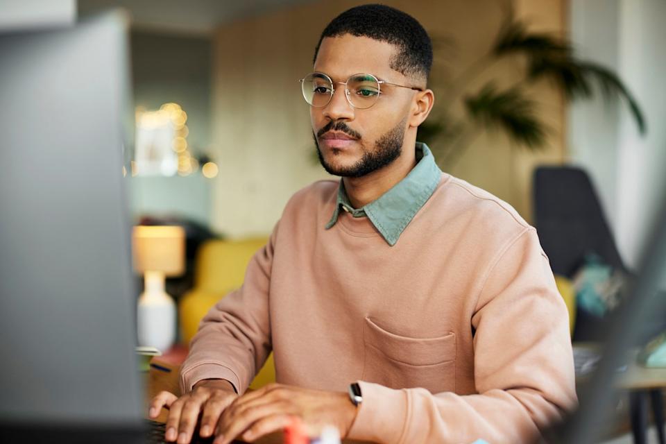 An investor works at a laptop.