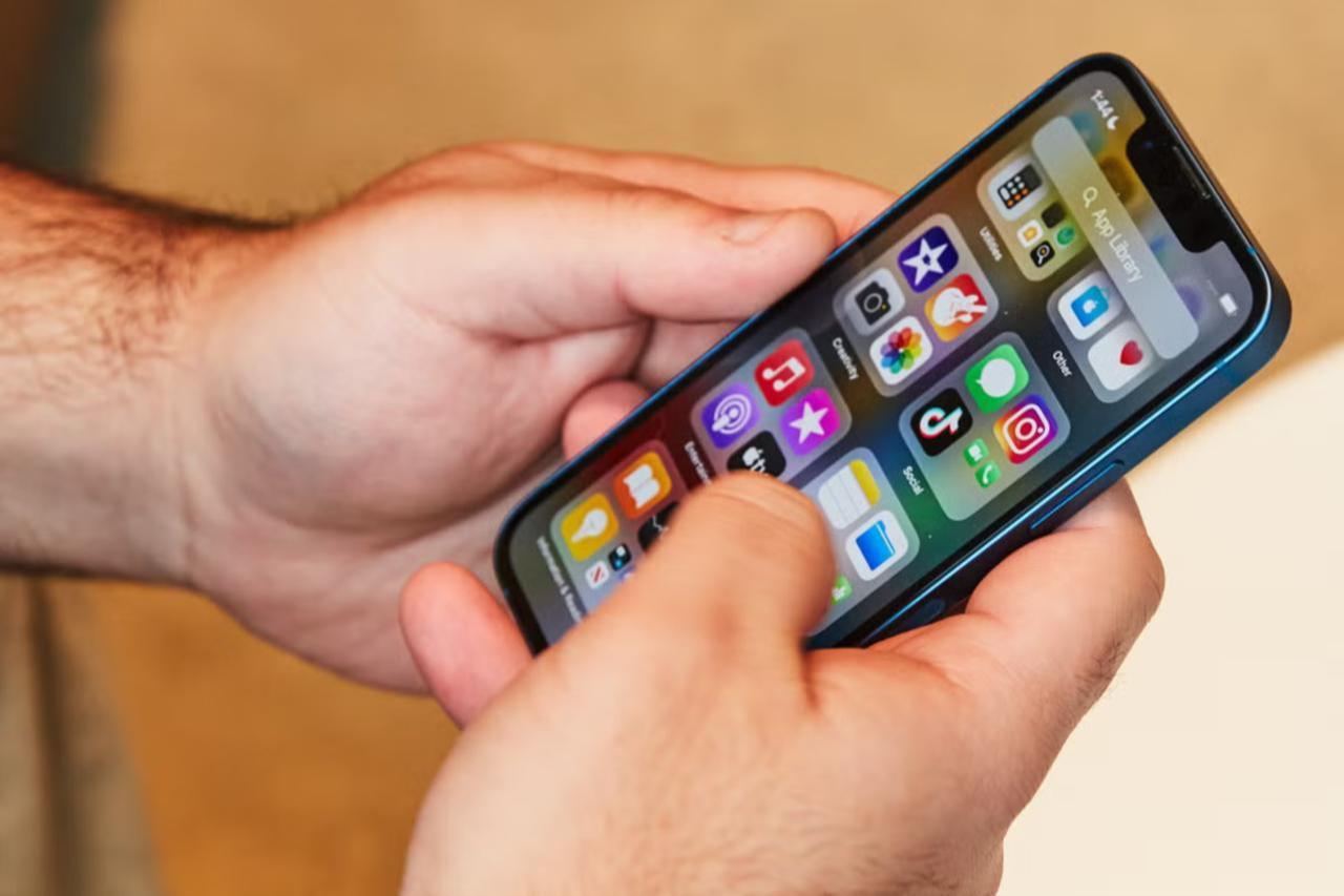 A person scrolling through social media on a smartphone. (Adobe Stock Photo)