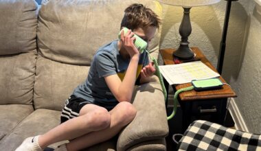 Jake Zobec, a Denver fourth-grader, speaks to his grandma on a landline telephone.