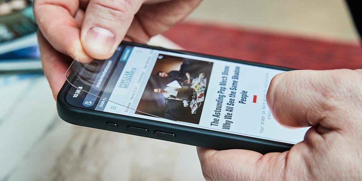 Applying a screen protector to a smartphone.