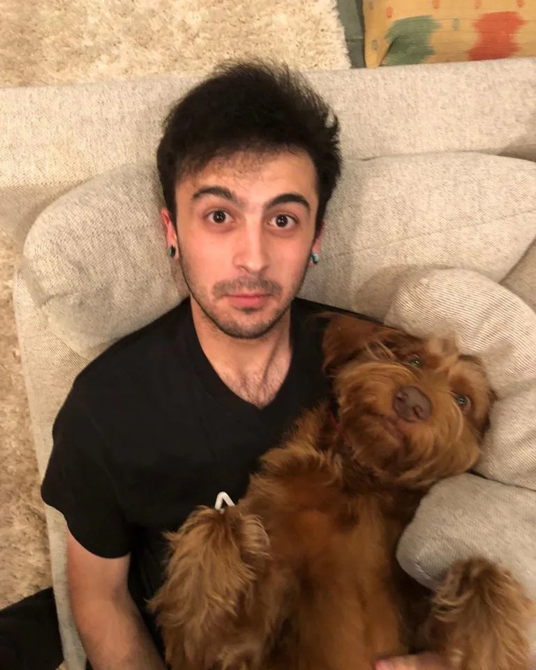 Annie Potts' son James Hayman poses for a photo with a dog.Credit: Annie Potts Instagram