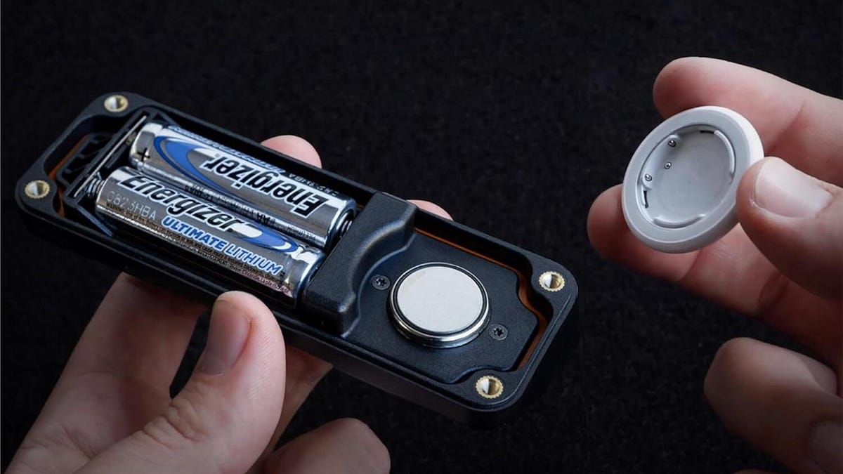 Elevation Lab AirTag case, open showing AirTag and 2 AA batteries