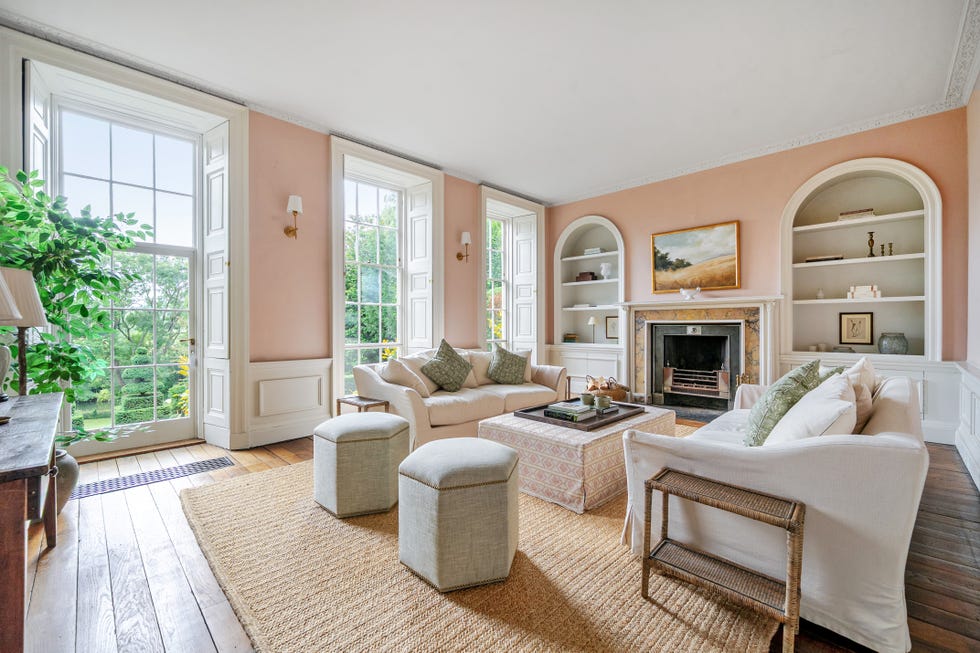 Bright, cozy living room with windows and a fireplace.