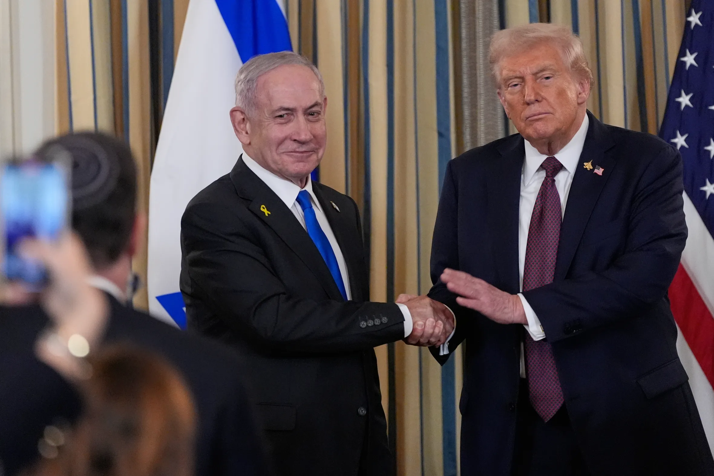 Prime Minister Benjamin Netanyahu shaking hands with President Donald Trump.