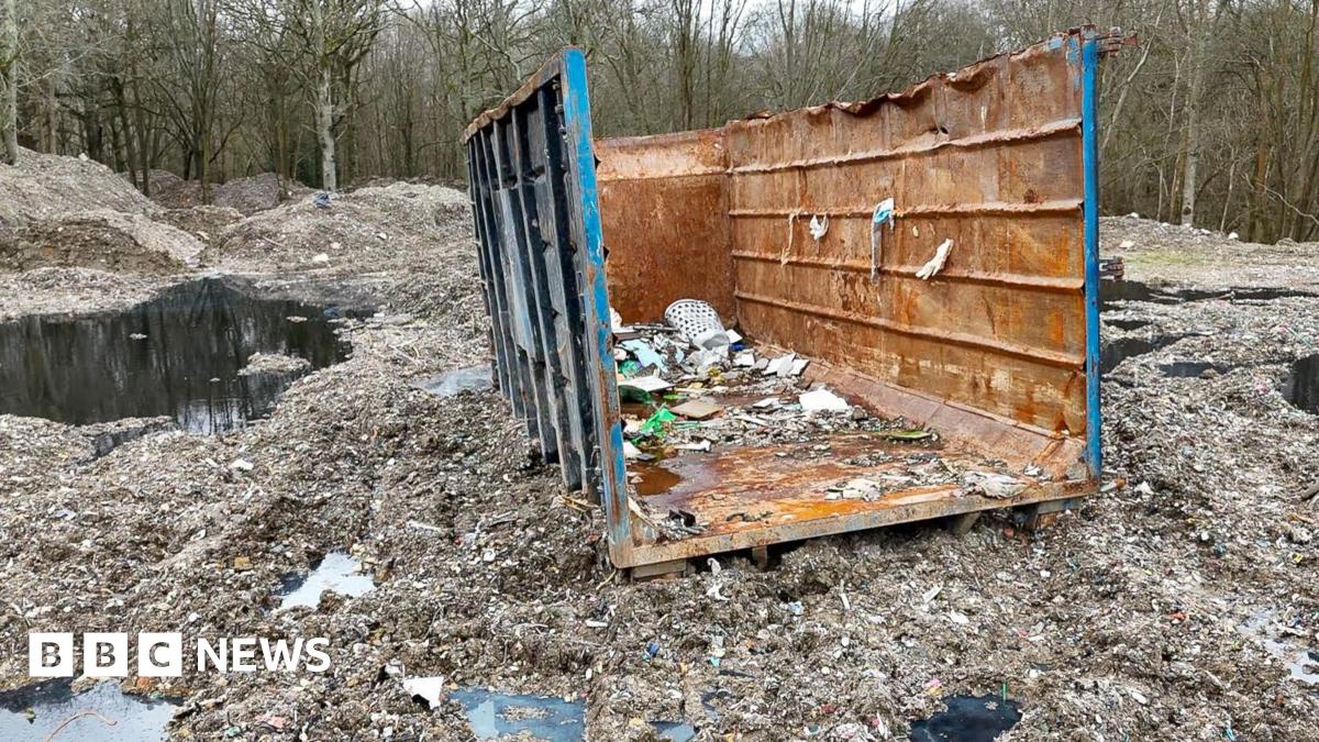 Marie McLaren smiles for the camera. She has short grey hair and is wearing a white scarf.