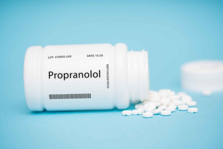 A bottle of propranolol, with pills spilling out.