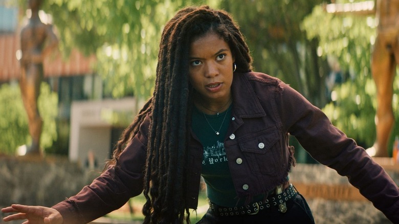 Marie Moreau stands cautiously with her arms outstretched