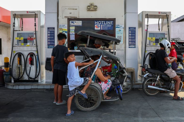 People refill their vehicles with fuel at a petrol station, following the arrival of Russian crude in the country amid a global energy crisis, in Limay, Bataan Province, Philippines, on April 2.