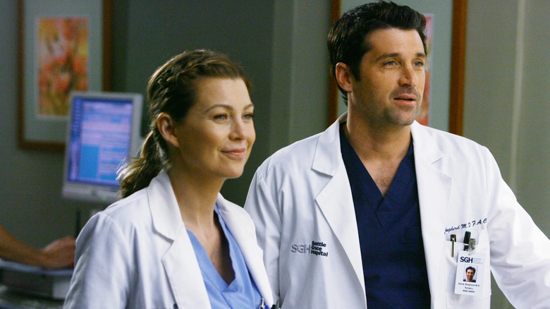 Ellen Pompeo as Meredith Grey stands next to Patrick Dempsey as Derek Shepherd in Grey's Anatomy