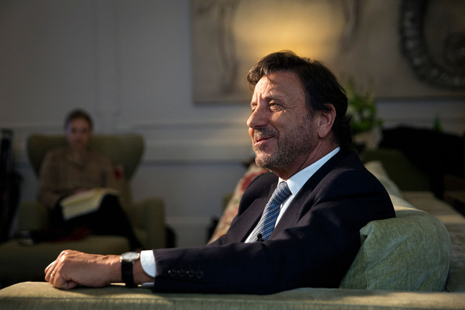 Sir Rocco Forte standing confidently in a luxury hotel lobby, showcasing elegance and hospitality leadership