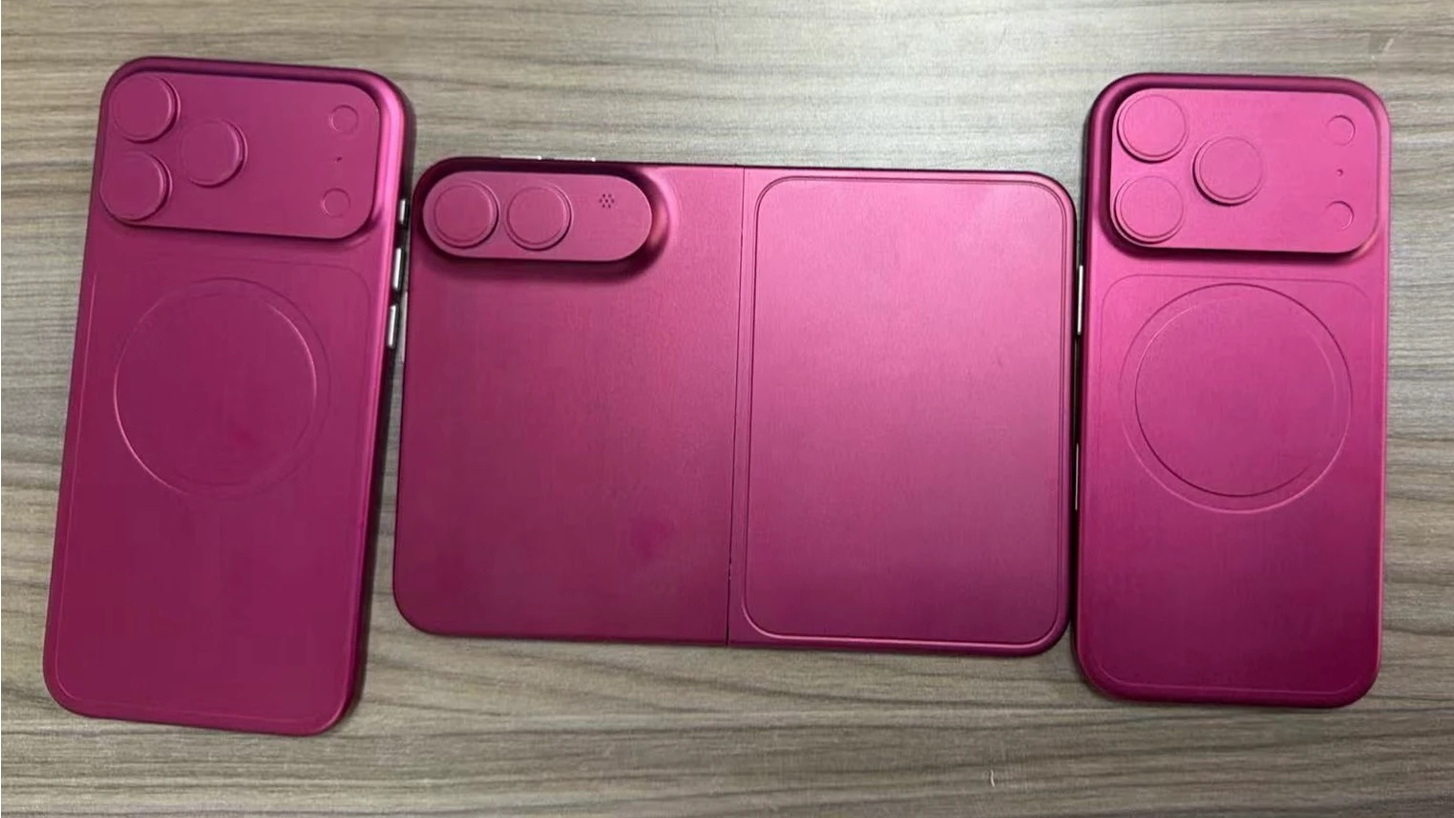 iPhone Fold dummy in magenta with two iPhones nearby.
