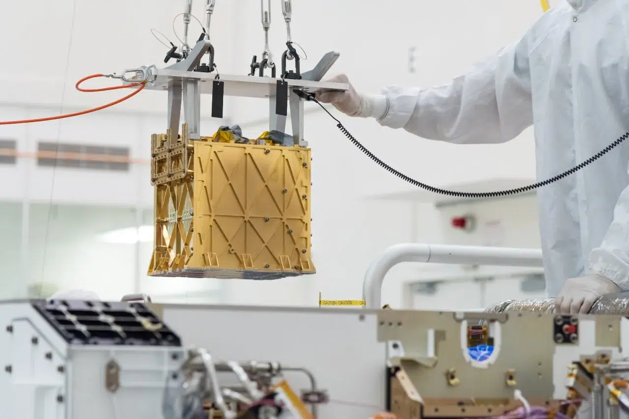Technicians at NASA’s Jet Propulsion Laboratory lower the Mars Oxygen In-Situ Resource Utilization Experiment (MOXIE) instrument into the belly of the Perseverance rover. Credits: NASA/JPL-Caltech
