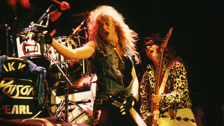 Poison on stage performing intensely