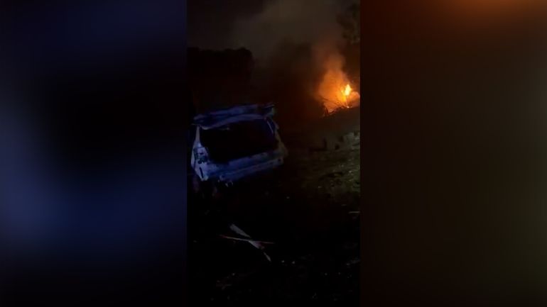 A fire and badly damaged vehicle are seen after an Iranian missile struck a residential area of northern Israel on March 13, 2026. [fireisrael7777 via Telegram]