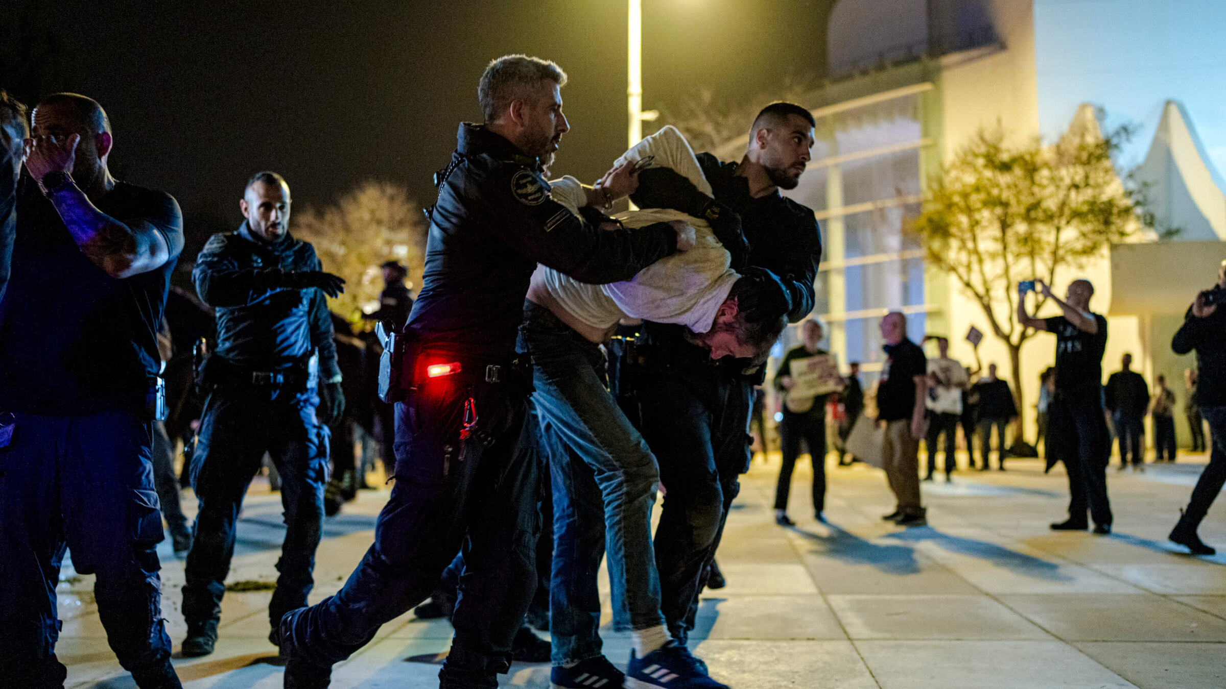 Israeli police arrest an anti-war protester amid a gathering in Habima Square in Tel Aviv on April 4.
