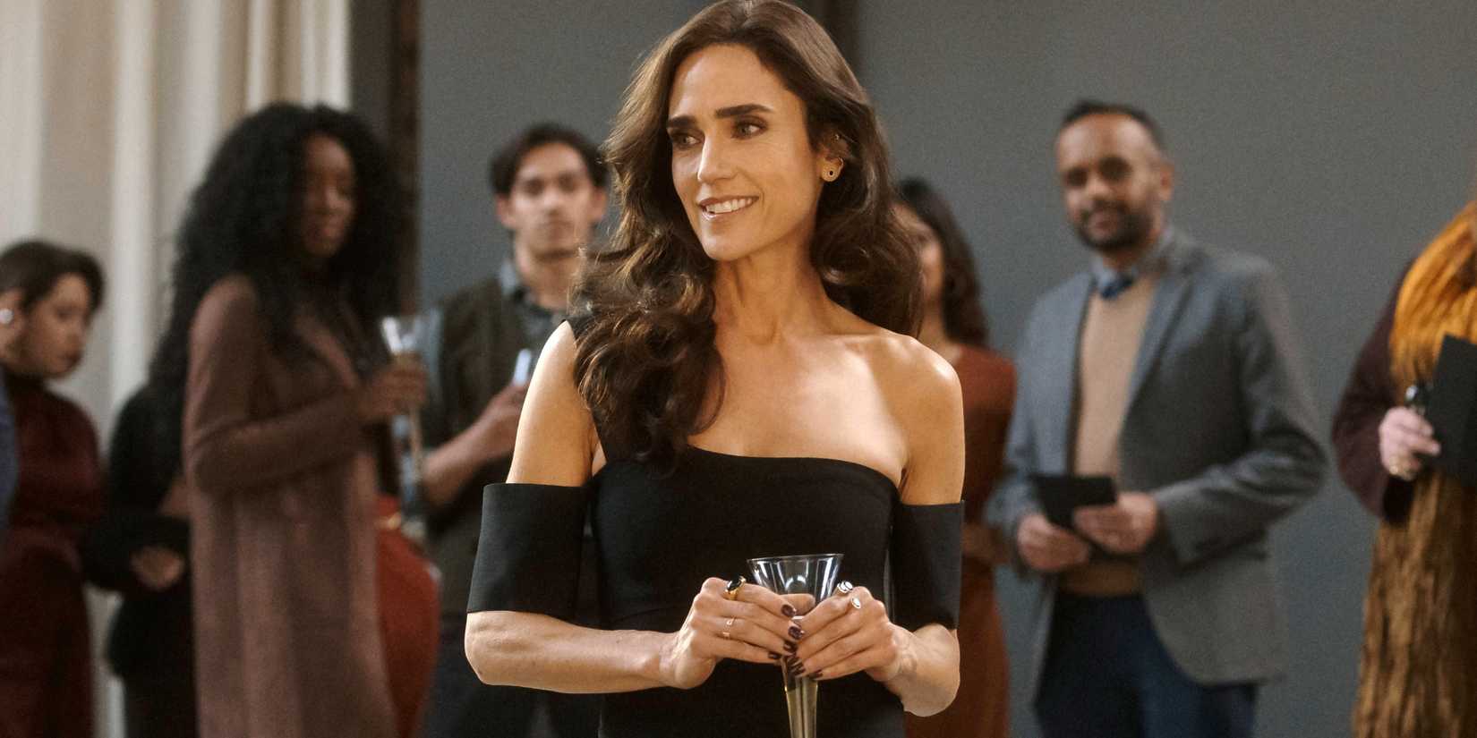 Jennifer Connelly as Daniela wearing a black dress and smiling while holding a glass in Dark Matter season 1