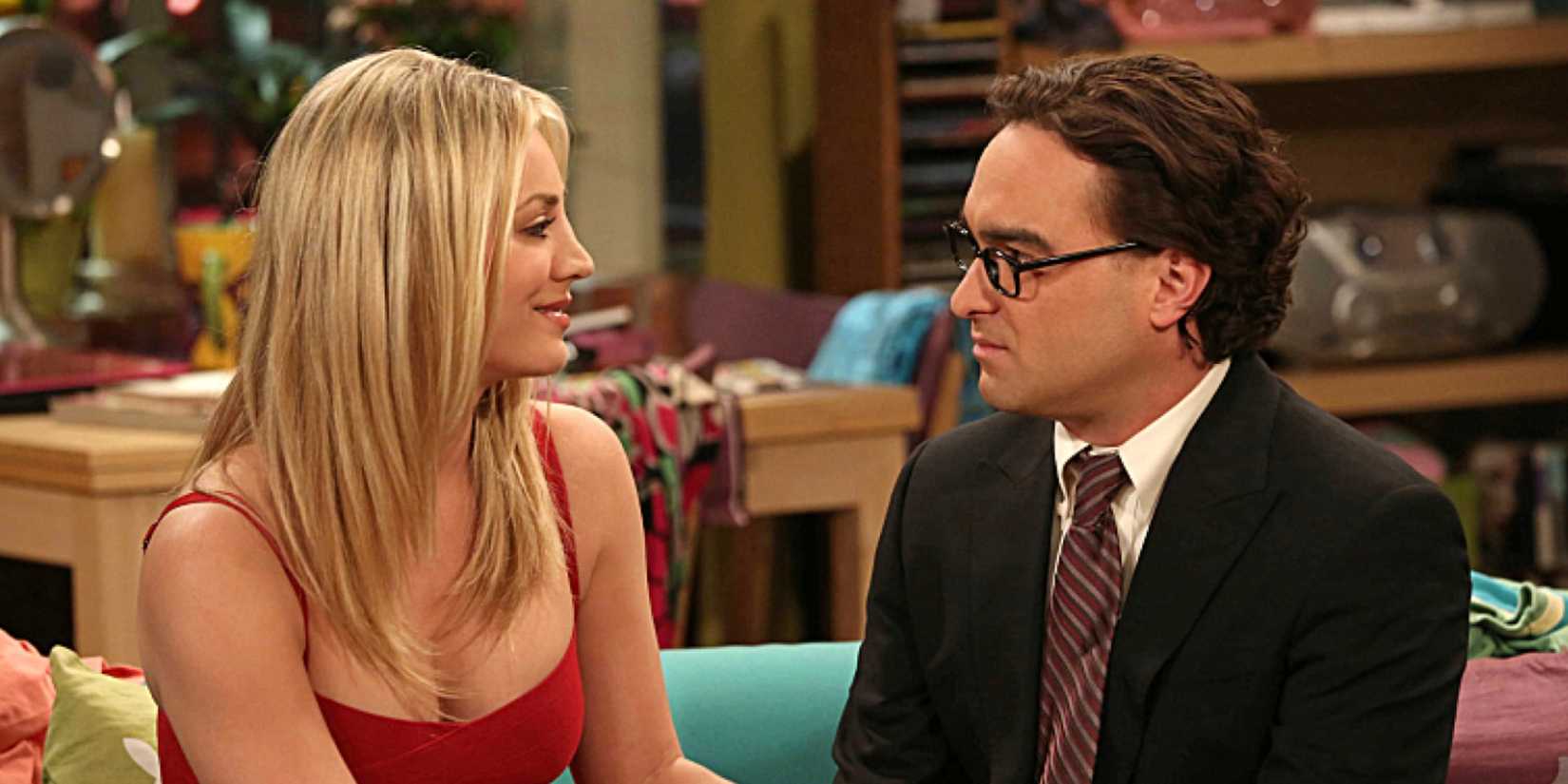 Penny and Leonard sit on a couch together in The Big Bang Theory