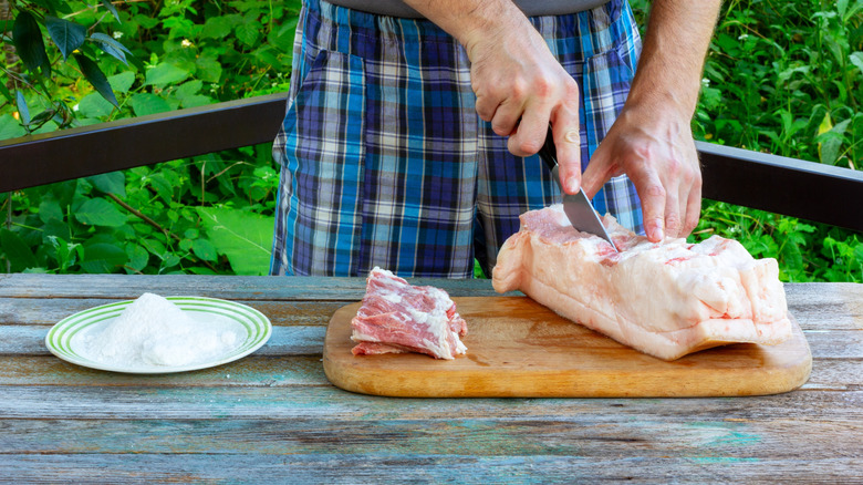 Cutting lard on a chopping board