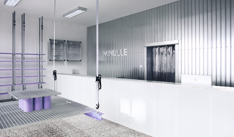 steel grates suspended from ratchet straps turn into furniture for bratislava photo lab - 1