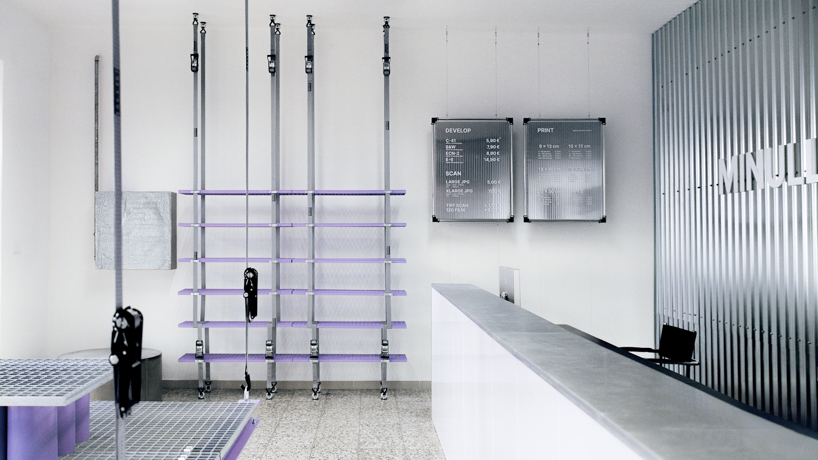 steel grates suspended from ratchet straps turn into furniture for bratislava photo lab - 2