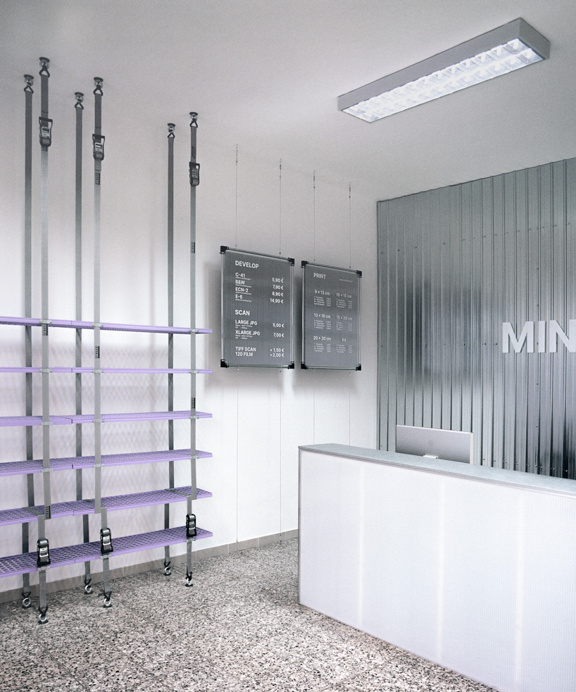 steel grates suspended from ratchet straps turn into furniture for bratislava photo lab - 4