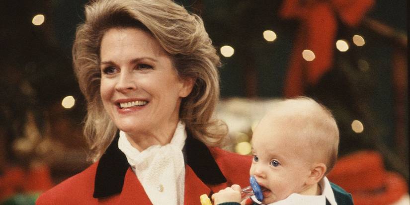Candice Bergen as Murphy Brown holding a baby
