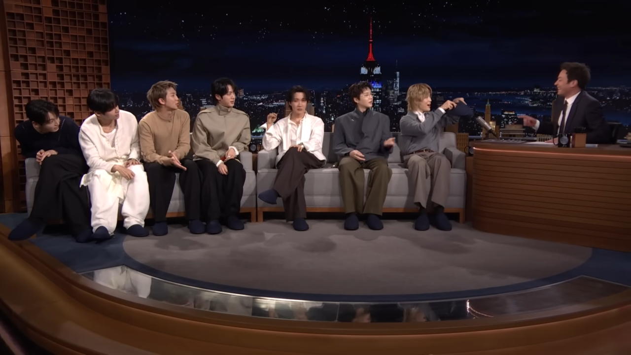 BTS gifts indoor slippers to Jimmy Fallon while starring on NBC's "The Tonight Show Starring Jimmy Fallon" on March 26. (@fallontonight, YouTube)