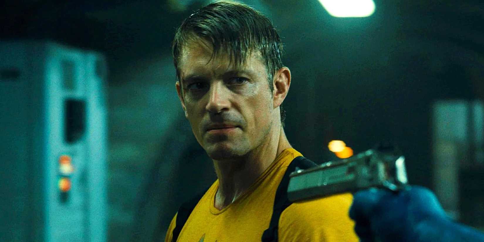 Rick Flag looking angry as Peacemaker points a gun at him in The Suicide Squad (2021)