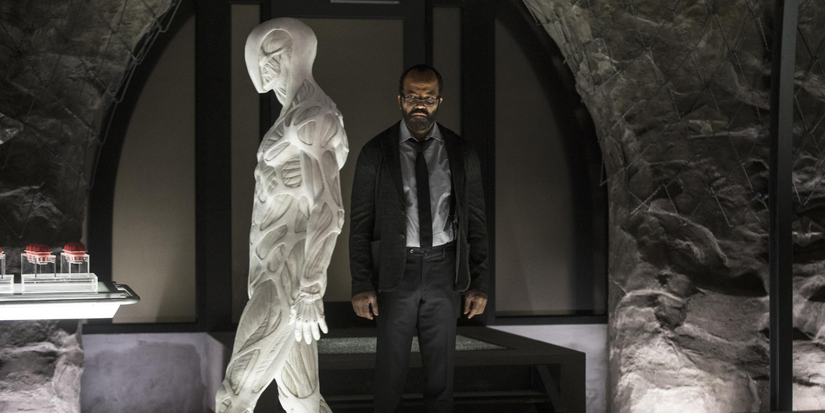 Bernard looks at a walking white humanoid robot