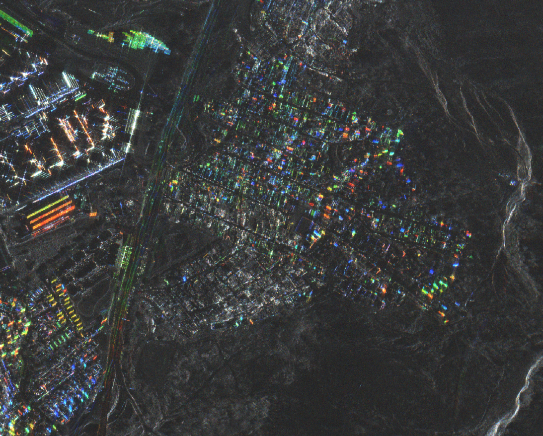 A radar image captured by ICEYE on January 22 reveals destruction in a section of Lirquén. Intact structures appear in vibrant color, while the muted gray cluster at lower center marks homes destroyed by the fire.