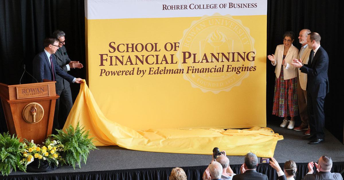 Speakers at the event unveil the new banner of the School of Financial Planning, powered by Edelman Financial Engines.