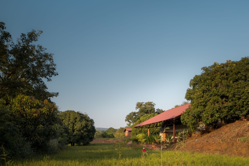 gabled roof floats over gathering pavilion’s brick stepped plinths in india - 2