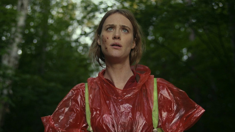 Kirsten wearing red poncho and looking up