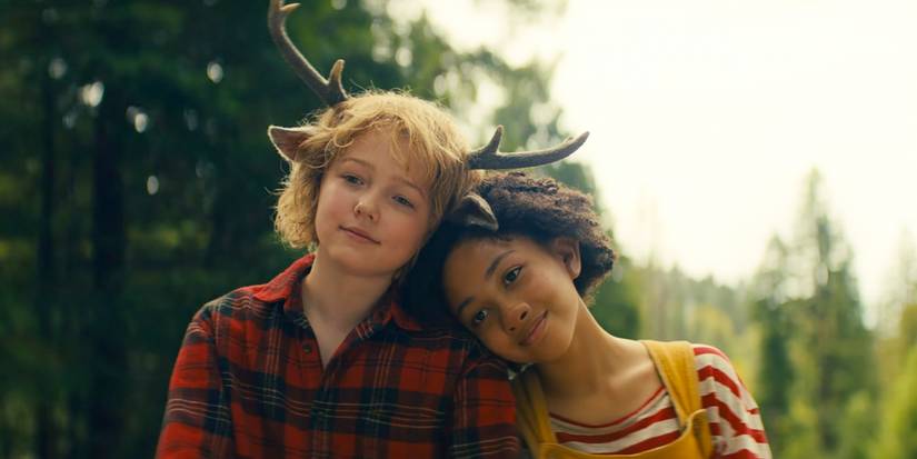 Wendy (Naledi Murray) resting her head on Gus (Christian Convery)'s shoulder in Sweet Tooth season 3