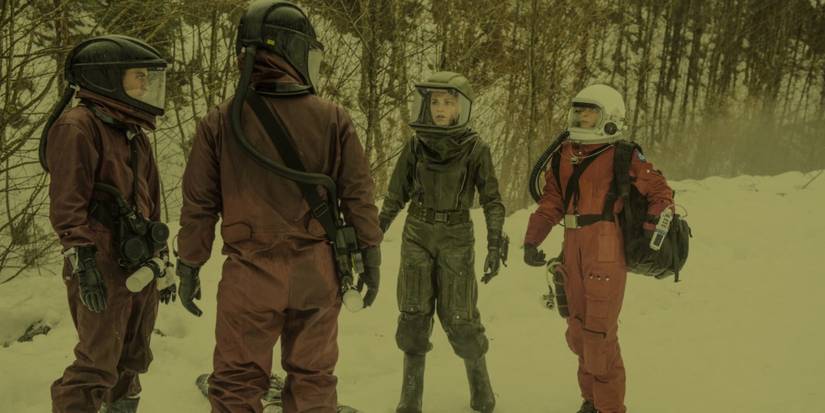 Clarke and her friends standing in the ash wearing hazmat suits in The 100 season 4 episode "Praimfaya"