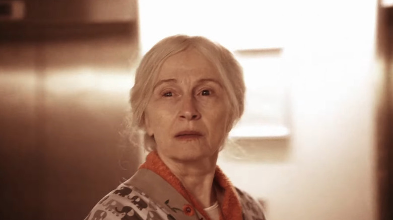 Bodil Jørgensen as Karen Svensson stands in front of an elevator in The Kingdom