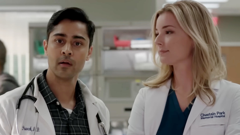 Manish Dayal as Dr. Devon Pravesh stands next to Emily VanCamp as Nicolette Nevin in The Resident