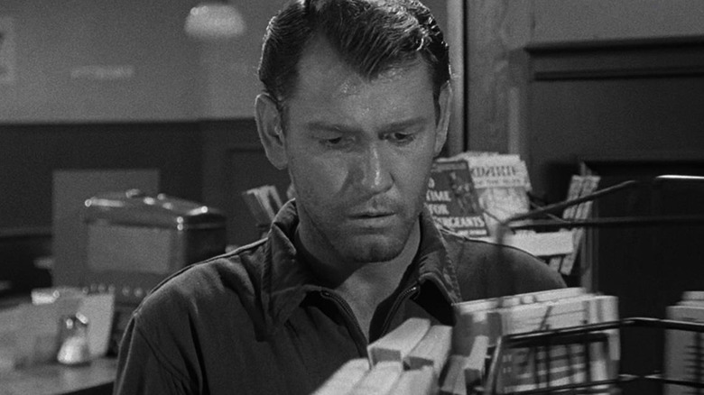 Mike Ferris (Earl Holliman) examines an empty store in The Twilight Zone