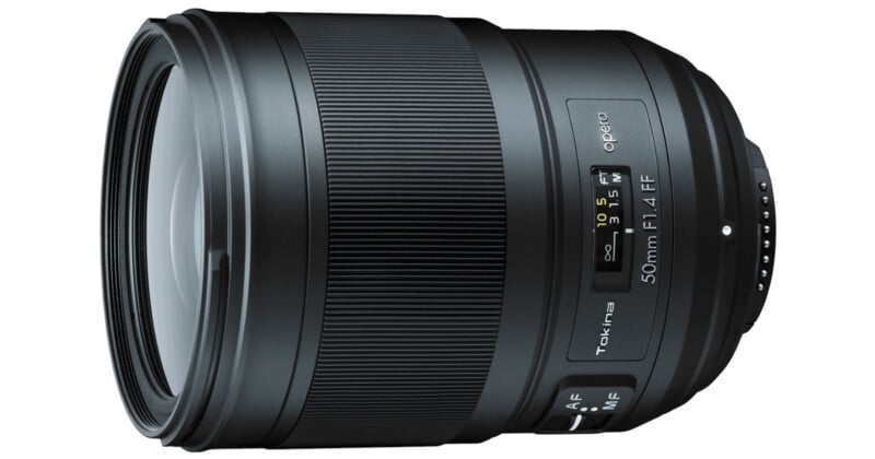 A close-up view of a Tokina opera 50mm f/1.4 FF camera lens, showing its focus ring, autofocus/manual switch, and distance scale against a white background.