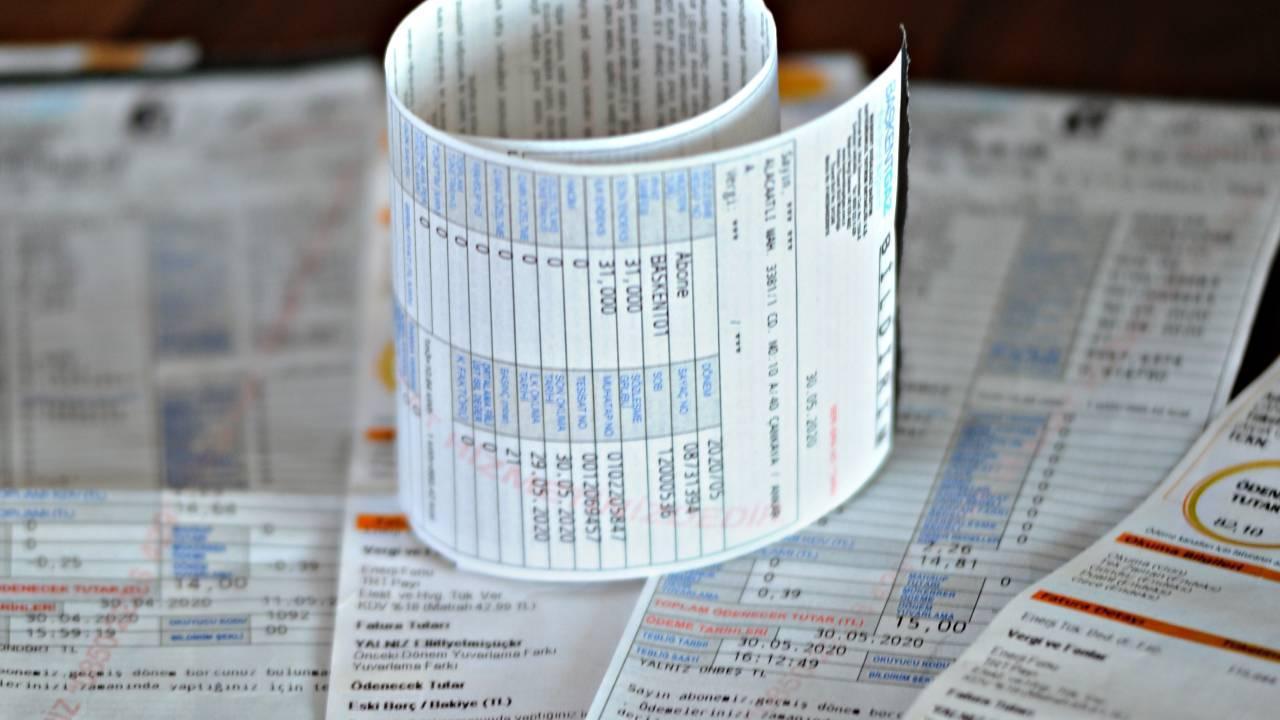 File photo shows a rolled-up natural gas bill placed on top of a stack of electricity and natural gas bills. (AA Photo)