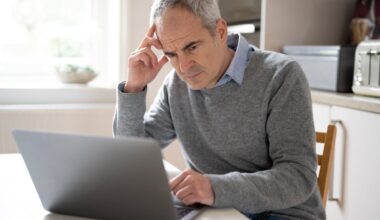 Person looking concerned while on laptop.