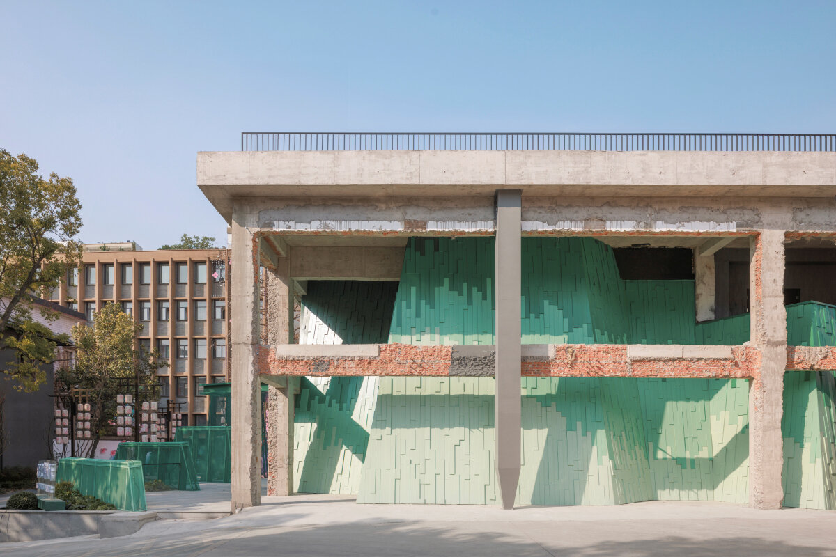 wutopia lab's layered green facade recalling chinese painting transforms factory into theater