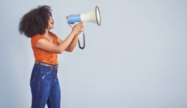 Black woman using loudspeaker to be heard