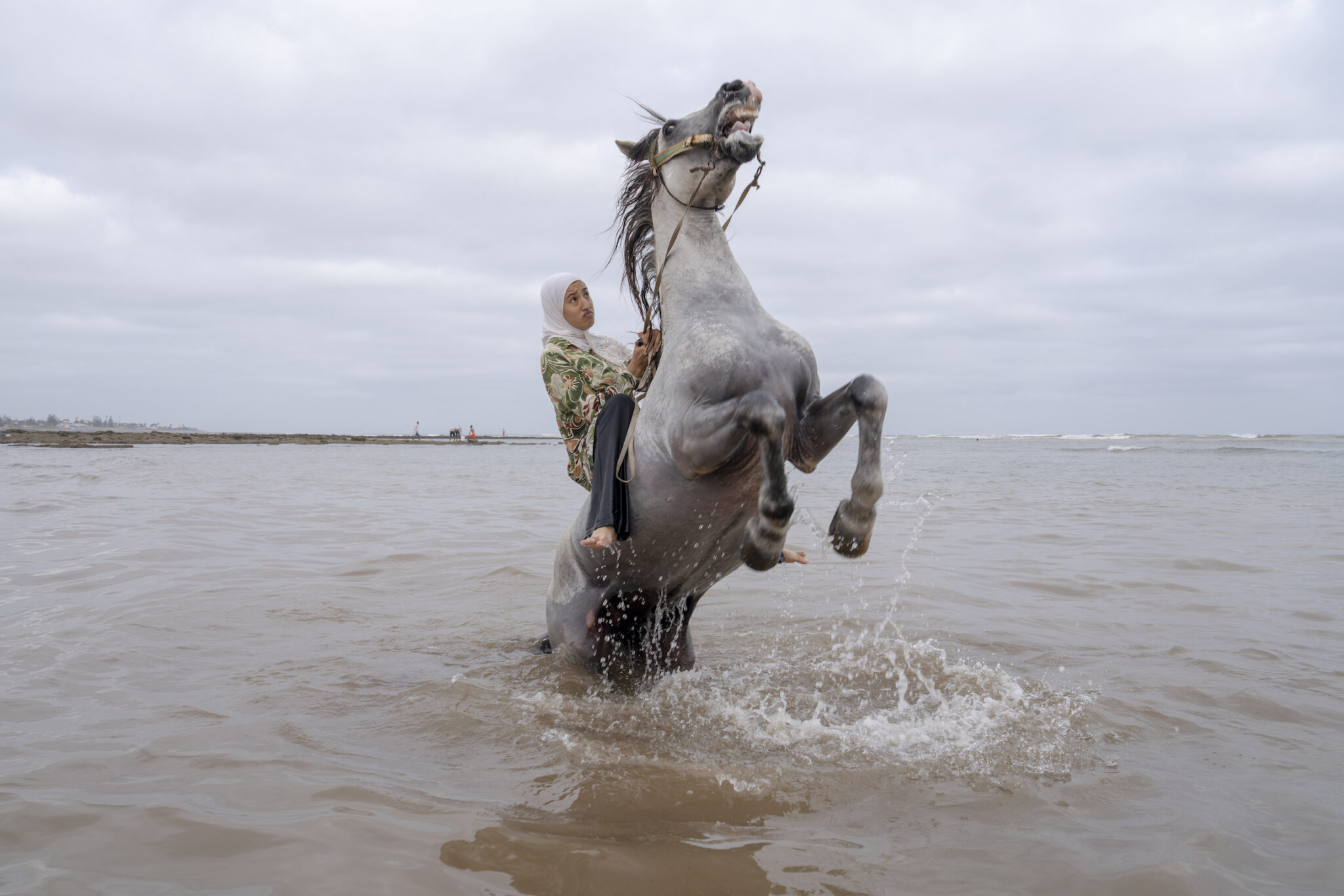 Chantal Pinzi, “Farīsāt: Gunpowder’s Daughters,” for Panos Pictures. Ghita Jhiate manages her unruly stallion. Long forbidden by her father to participate in Tbourida, she finally realized her dream of riding alongside pioneer Zahia Aboulait in 2025. Sidi Rahal, Morocco, August 6, 2025.